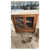 Cabinet with wire doors and vintage salami box