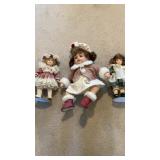 Three porcelain face dolls.