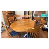 Oak pedestal table with six pressed back chairs