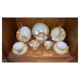 Tea set with flowers and oranges