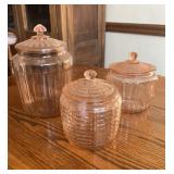 Set of pink depression glass canisters with lids