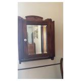 Small vintage wood cabinet with mirror indoor,