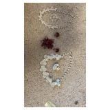 Three sets of jewelry, including necklaces,