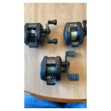 Three bait casters, including Abu Garcia 52IXLT