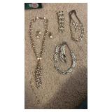 Three sets of jewelry not marked