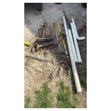 Assortment of garden tools, including brooms,