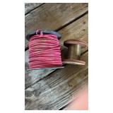 Two rolls of wire one is 12 gauge stranded red,