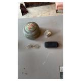 Musical powder, box and wire rim glasses