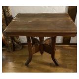 Vintage Parlor Table with hand carving and rollers