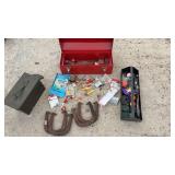 Toolbox with old fishing gear, horseshoes, and