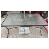 Glass top table and five metal chairs, table is