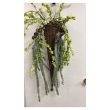 Tall woven wicker cone wall basket filled with