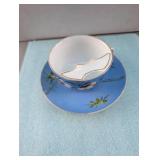 Mustache cup with cracked saucer