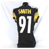 Pittsburgh Steelers #91 Aaron Smith Game Used Home Jersey. Reebok jersey used by defensive lineman Aaron Smith. Jersey has a 2008 year tag. Jersey has several team repairs, custom tailoring, scrapes, 