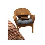 Wicker Arm Chair with Various Sizes of Picture Frames