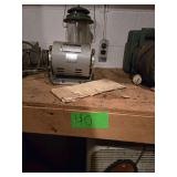 Contents of Bottom Shelf and Floor Beneath Shelf Including Vintage Kenmore Vacuum Cleaner, Coleman Lantern, Dishes, Electric Motors, Sleeping Bag