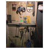 Contents on Wall Including Saw, Drag Light, Clamp