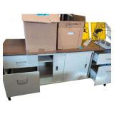 Filing Cabinet Credenza. Paper Punch. Adding Machine with Tape.  Metal Bookends. Paper Trays and Rack. Large Binders. Multi Plug. 2 Yellow Signs.