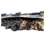 2 Stacks of Wood on Side of Garage