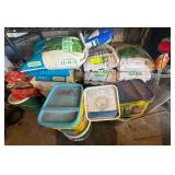 Contents of Bottom 2 Shelves - Several Bags of Pelletized Limestone Neutralizer - Bags of Fertilizer - Lime - Other Product