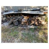 2 Stacks of Wood on Side of Garage