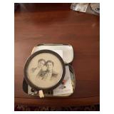 assortment of pins and vintage photo in oval frame