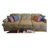 Flowered Pattern Couch with Muted Colors of Orange and Green