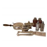Assortment of Silver Plated Serving Pieces Including Salt Cellar with Glass Insert, Lighter, Salt and Pepper Shakers, Tongs