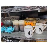 Assortment of Household Tabletop Decorations: Fruit Bowl, Candles, and Mugs with Letters.