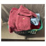 Assorted Bath Towels In Green Laundry Basket
