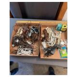 Assorted Electrical Cords Plugs Adapters and Bottl