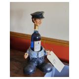 WINE BOTTLE W/COLORED WATER IN IT W/POLICE MAN