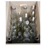 BOX OF GLASS BOTTLES USED FOR WINE MAKING
