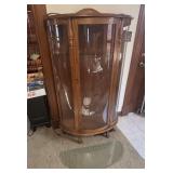 Oak curio cabinet with bowed front glass