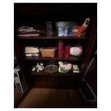 Contents of shelf candles & books & christmas ligh