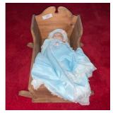 Blue Baby Doll in Wooden Cradle.