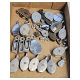Flat of various small metal pulleys