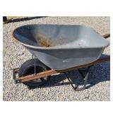 Used Gray Metal Wheelbarrow with Wooden Handles