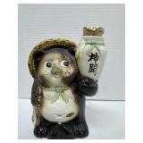 Shigarakiware Tanuki Holding a Sake Bottle