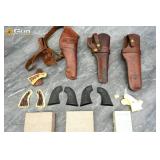 Revolver grips and leather holsters. Fair Conditio