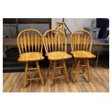 THREE WOODEN SWIVEL BAR STOOLS