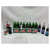 Assorted Soda Bottles: Coca-Cola, Mountain Dew, and Pepsi