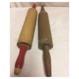 Two old dough rollers, red handled
