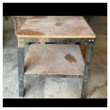 Workbench with metal frame and wood top.