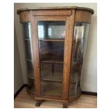 Antique Tiger Oak Curved glass curio cabinet.