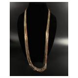 Multi-strand necklace with golden, silver, and
