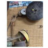 Brown Farm Tool Pegboard with miscellaneous tools