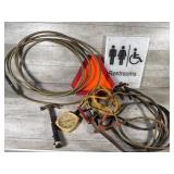 Jumper cables, restroom sign, air pressure hose