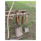 Wood table horses, hay sickle, shovels