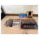 Drill bit sets, and coping saw blades